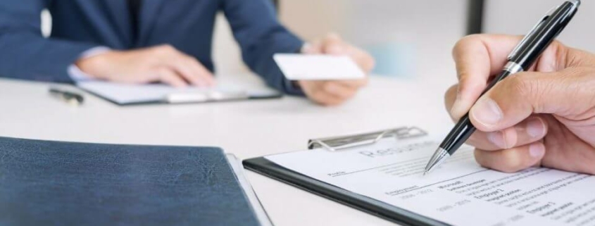 Signing documents during business meeting.