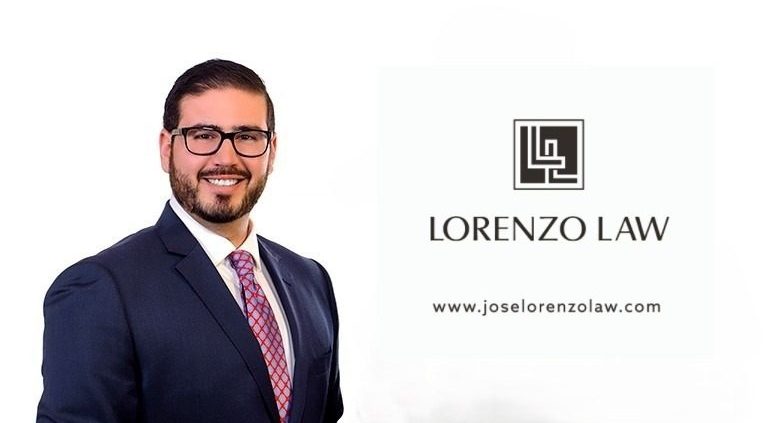 Man in suit beside law firm logo.