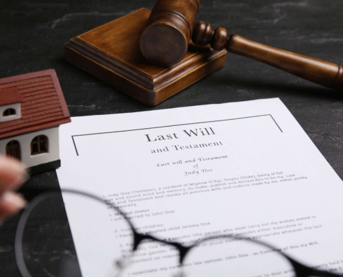 Last will document with gavel and house.
