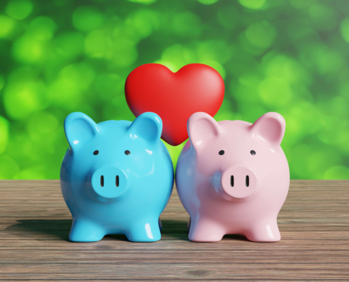 Blue and pink piggy banks with heart.