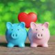 Blue and pink piggy banks with heart.
