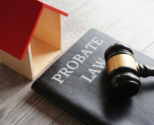 Gavel, house model, and probate law book.